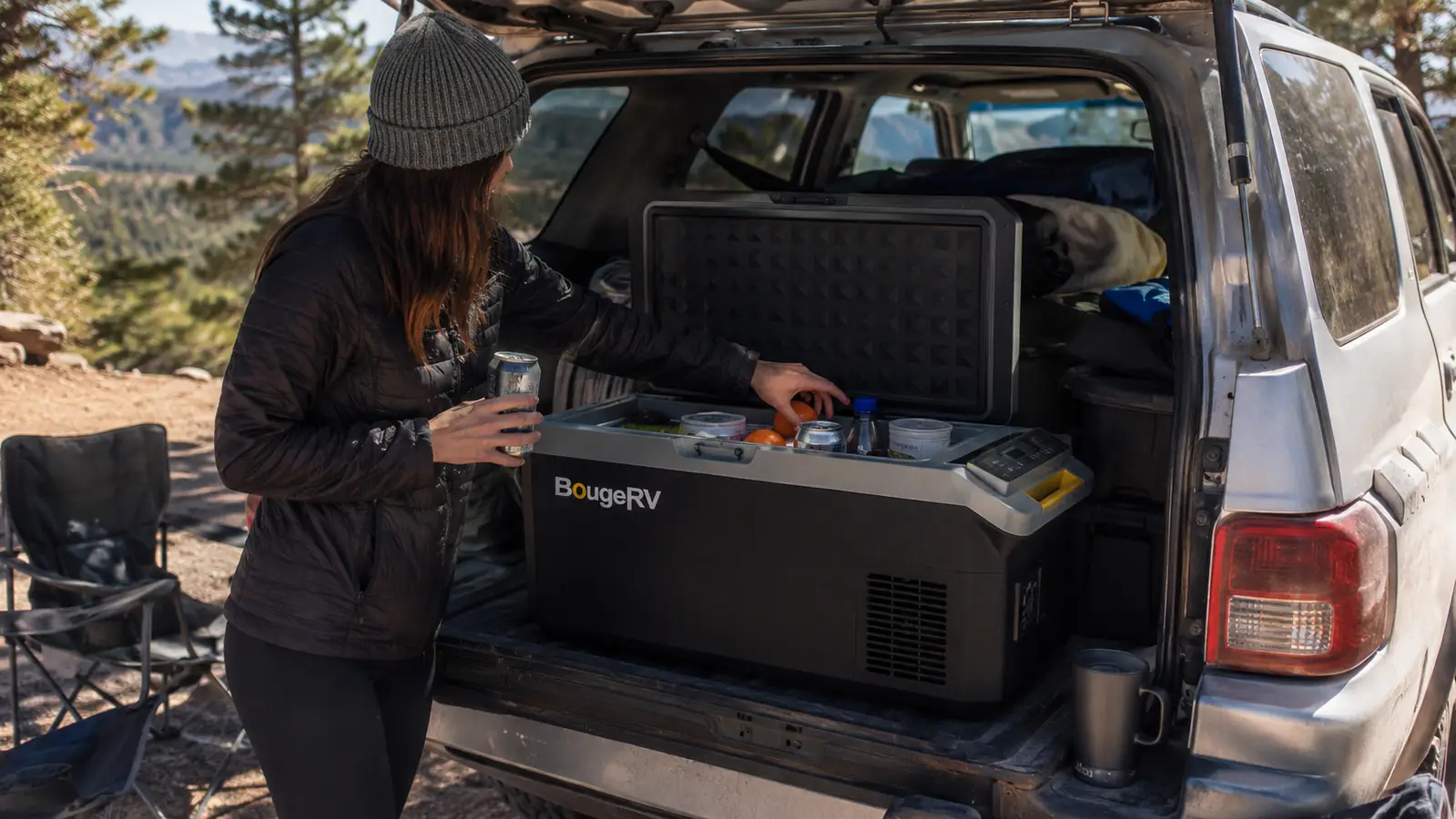 BougeRV 12V fridge open on a tailgate at a campsite showing packed groceries and drinks